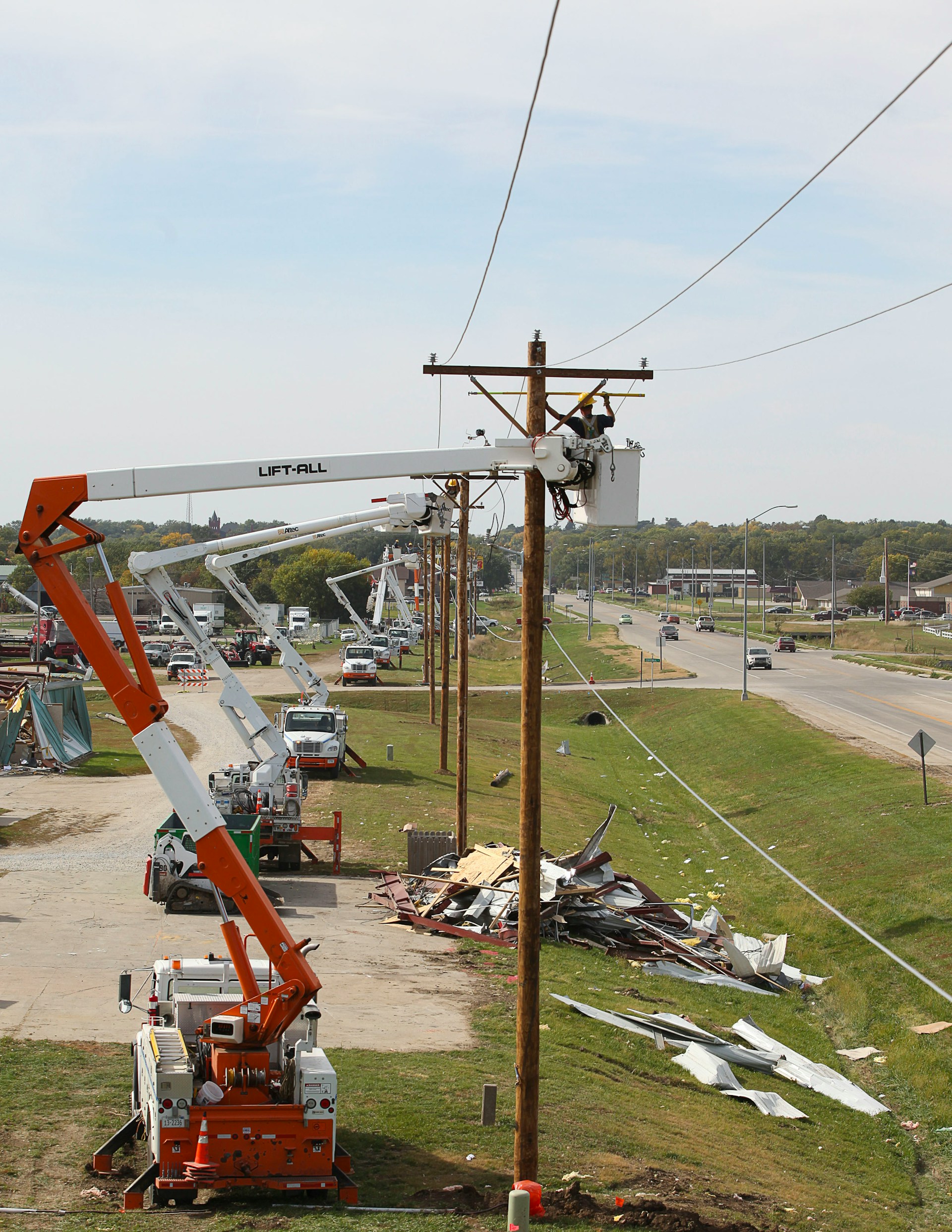 Line crew working from a bucket truck on utility power and cable lines